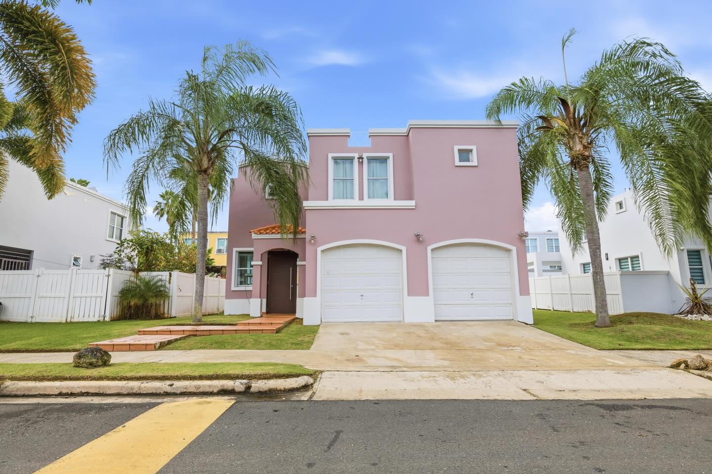 La Palma House, the signature pink townhome framed by royal palms